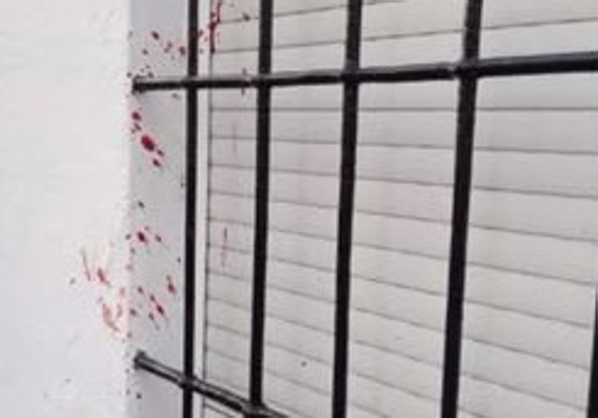 Traces of blood on the wall of a house in the street where the incident happened.